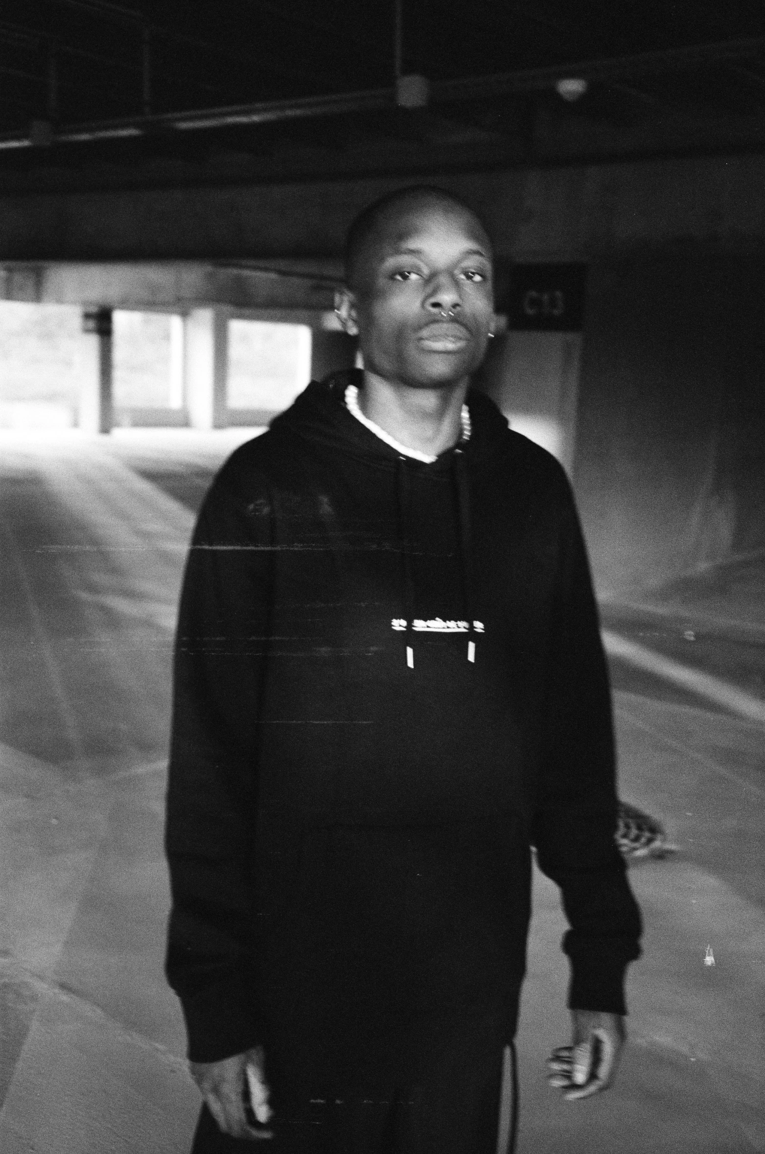 a person standing next to an empty parking garage