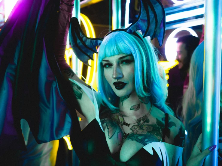 a woman with blue hair wearing horns and a cosplay