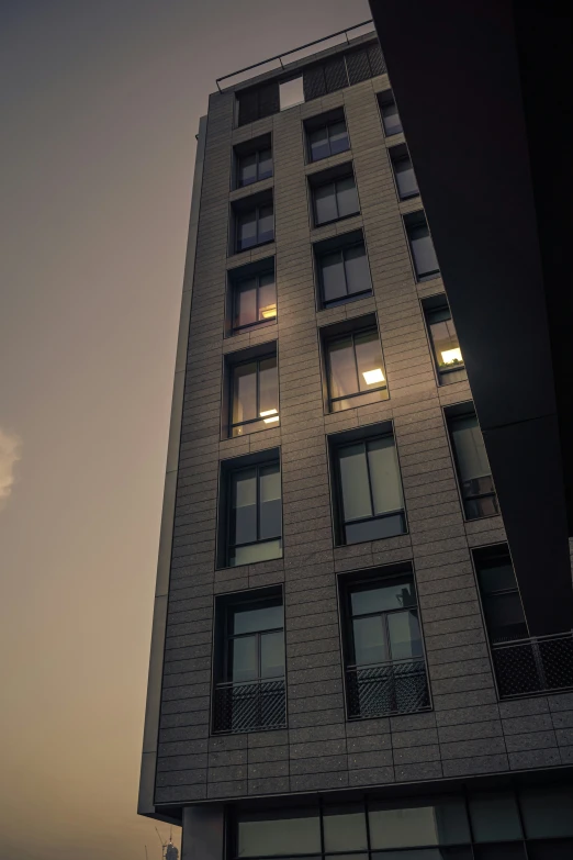 a tall building is illuminated by the night sky