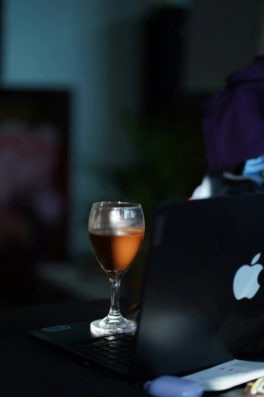 an apple drink and apple laptop computer on a table