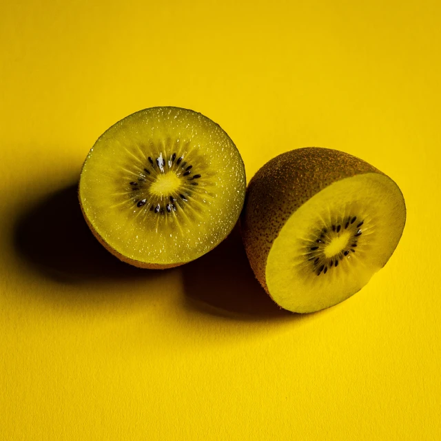 an image of two pieces of fruit on yellow background