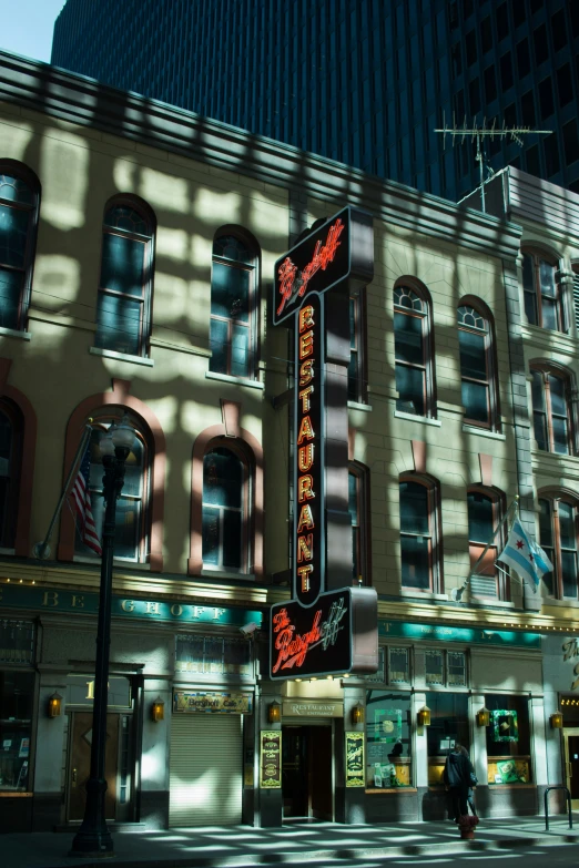 the side of an old fashioned theatre building in the sun