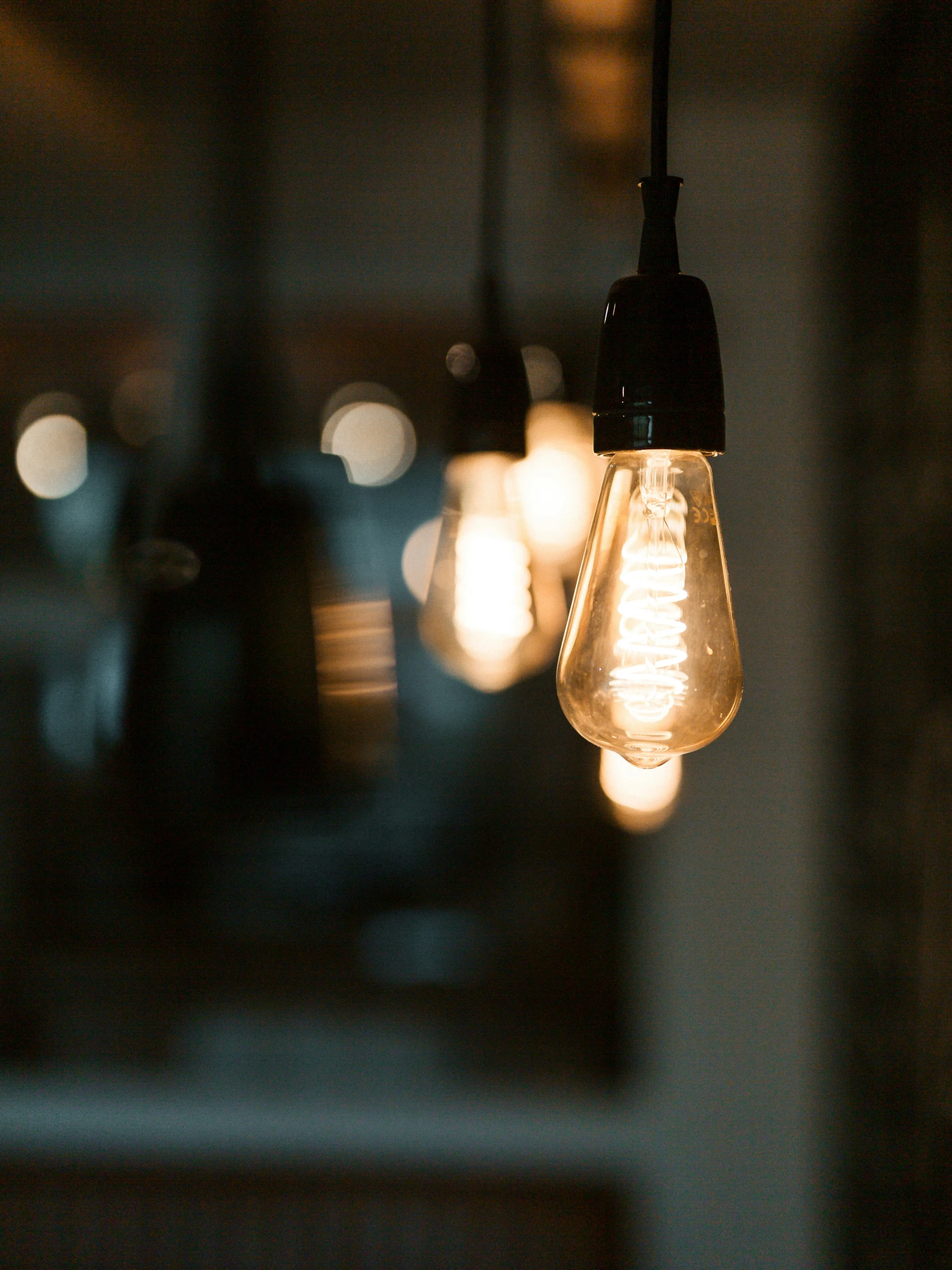 a light bulb hanging from the ceiling next to some other lights