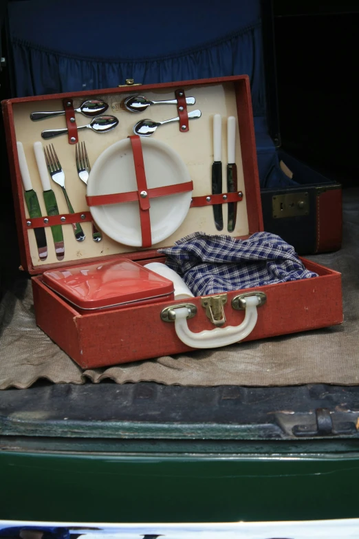 an open briefcase containing various items for dining