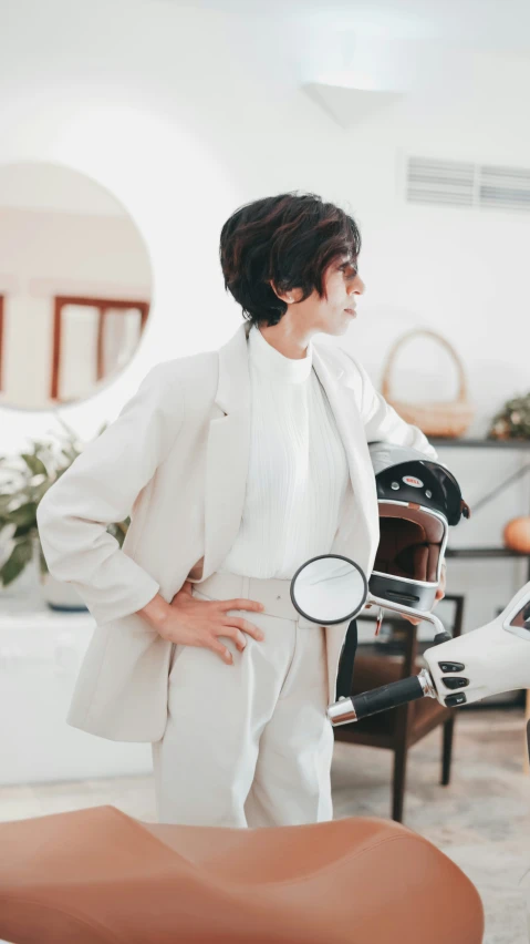 a woman stands near the hair dryer in a salon