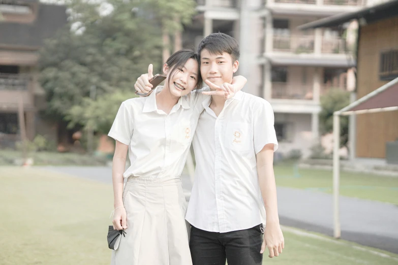 a man and woman pose for a po in front of an apartment building