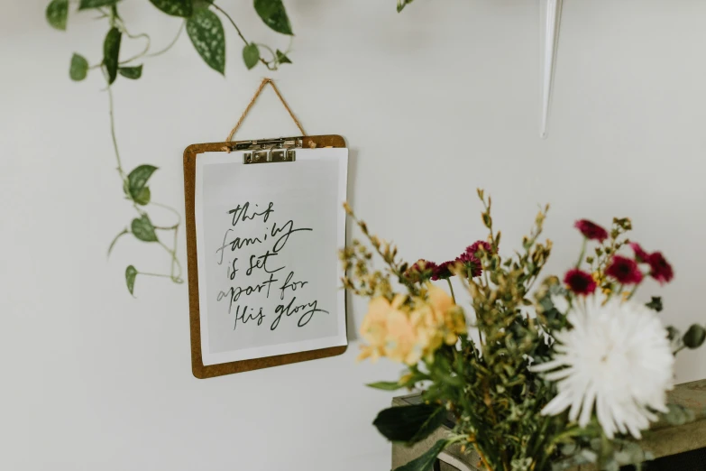 a picture with a flower arrangement next to a white wall