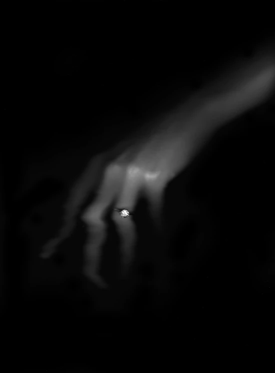 a blurry po of a person's hand reaching for soing