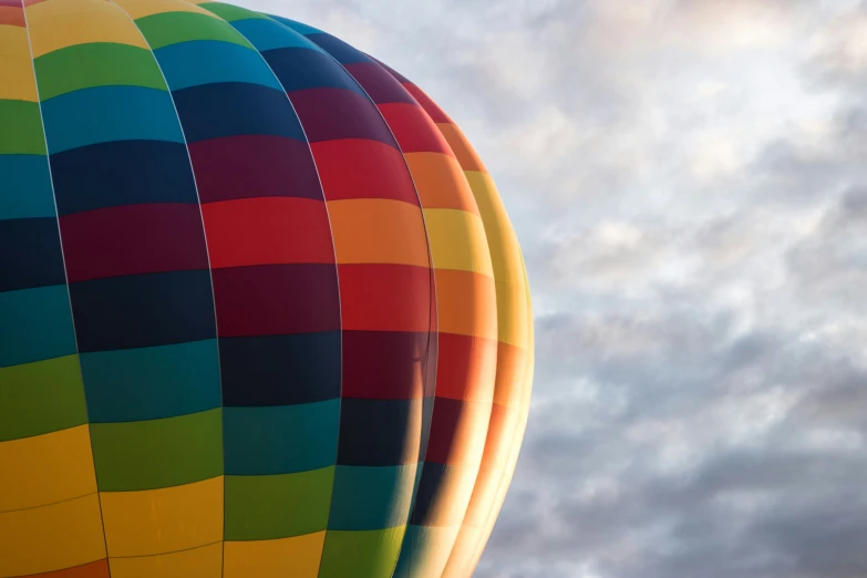 colorful  air balloons are flying against a cloudy sky