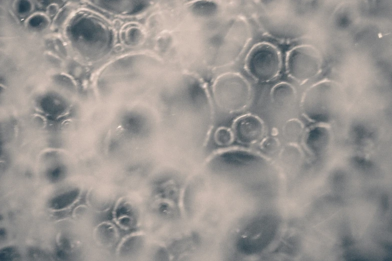 a bunch of bubbles are covered in condent droplets