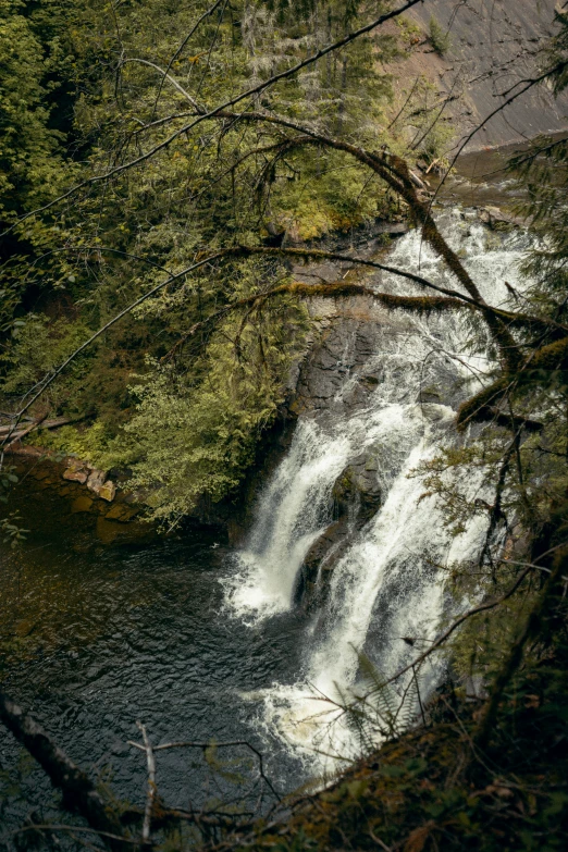 there is water running down the side of a large waterfall