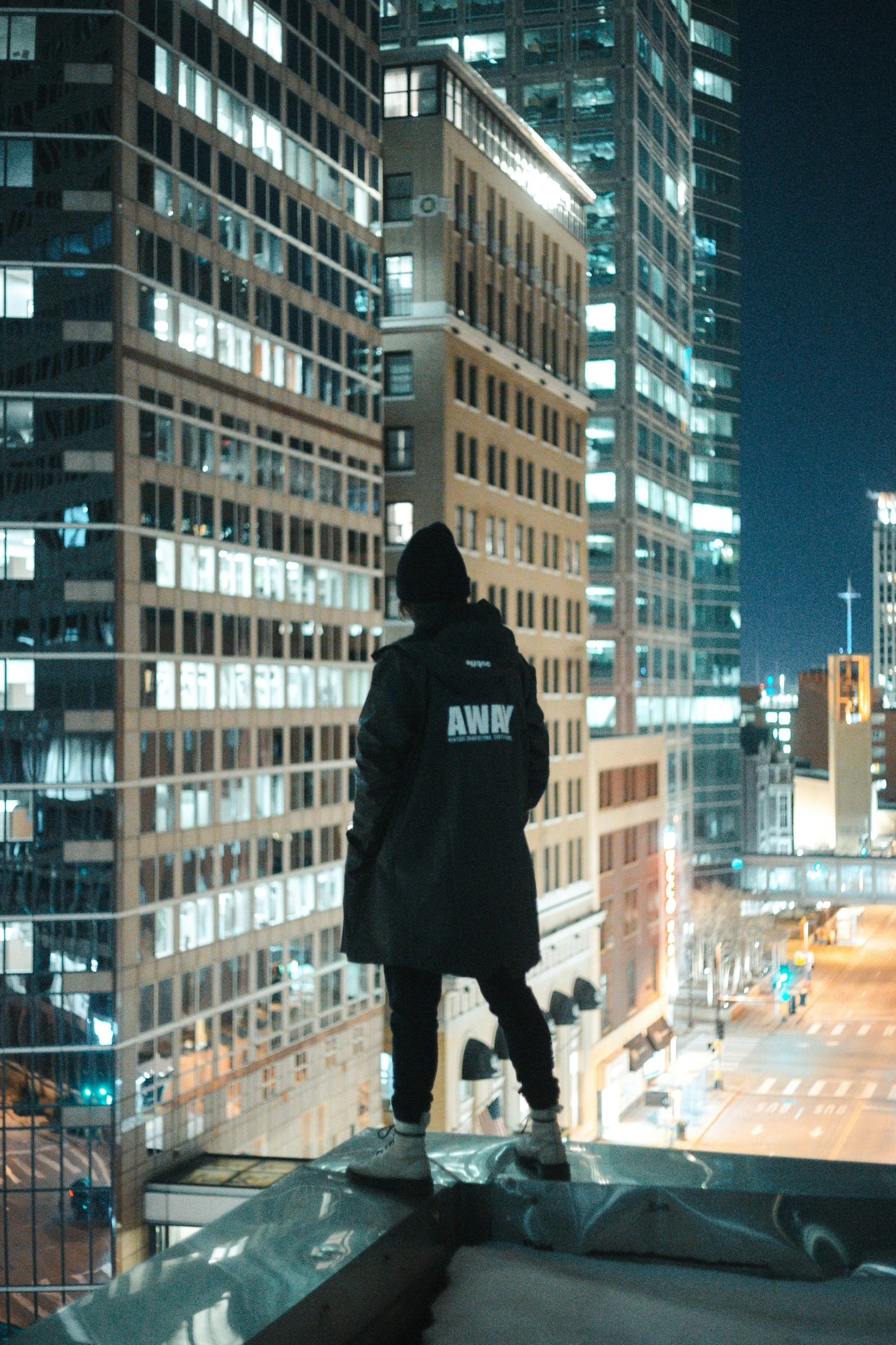 a person standing on the edge of a high rise