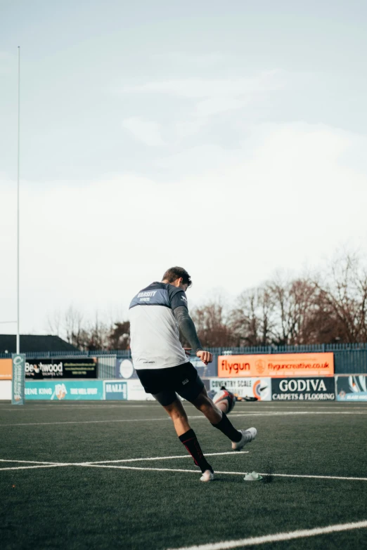 a man with his leg in the air trying to kick a soccer ball