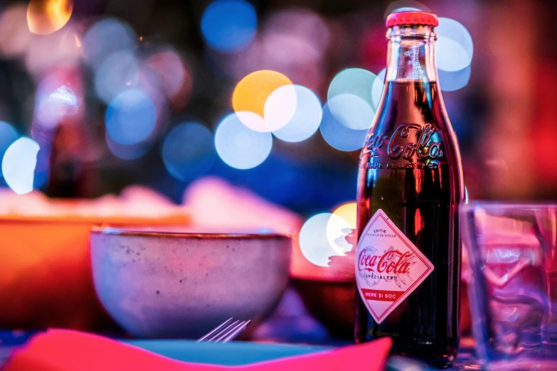 an empty coca cola bottle on a table