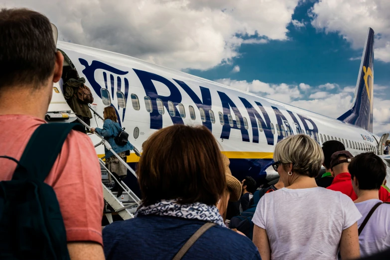 an airplane sitting next to a group of people