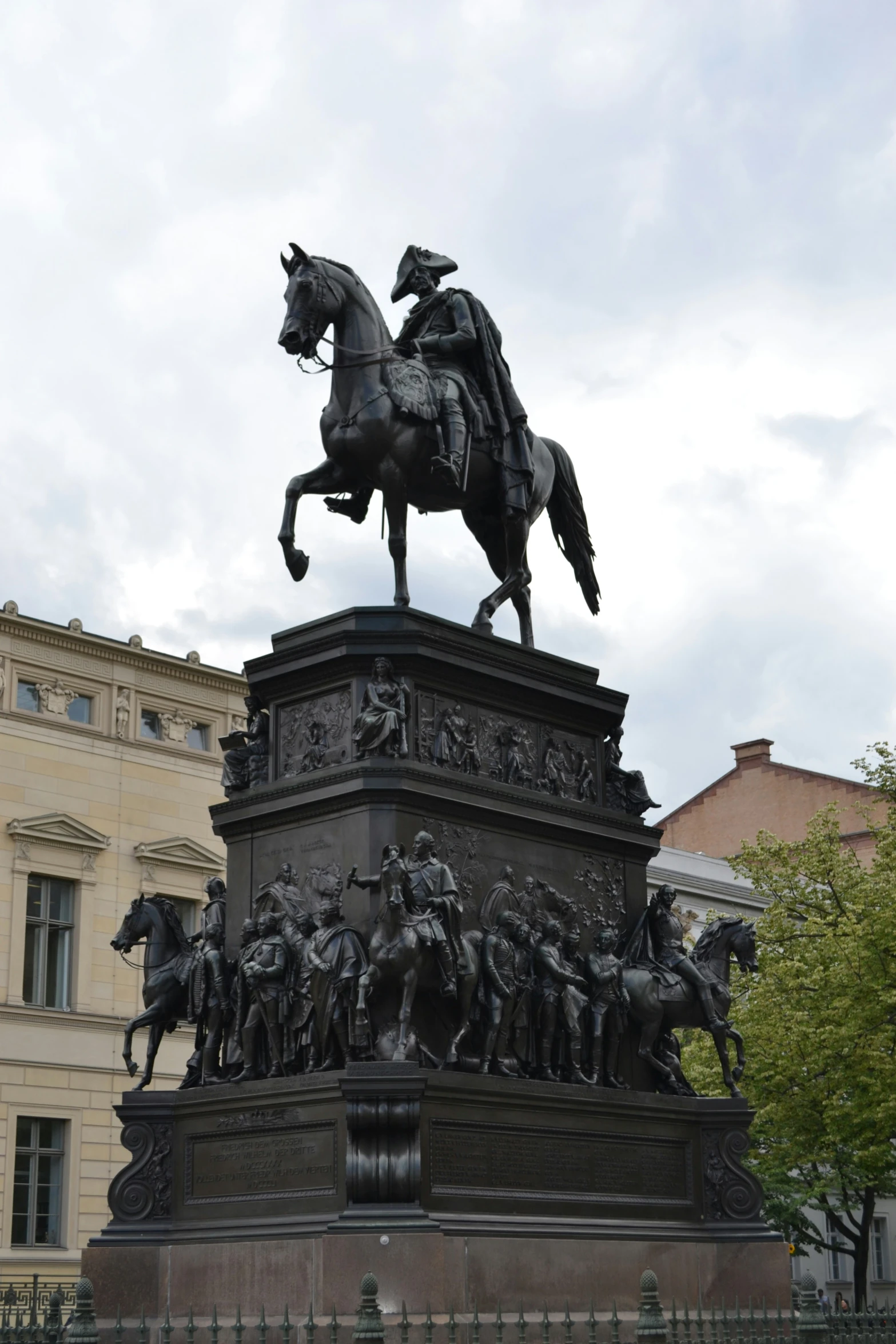 a statue of a man riding on top of a horse