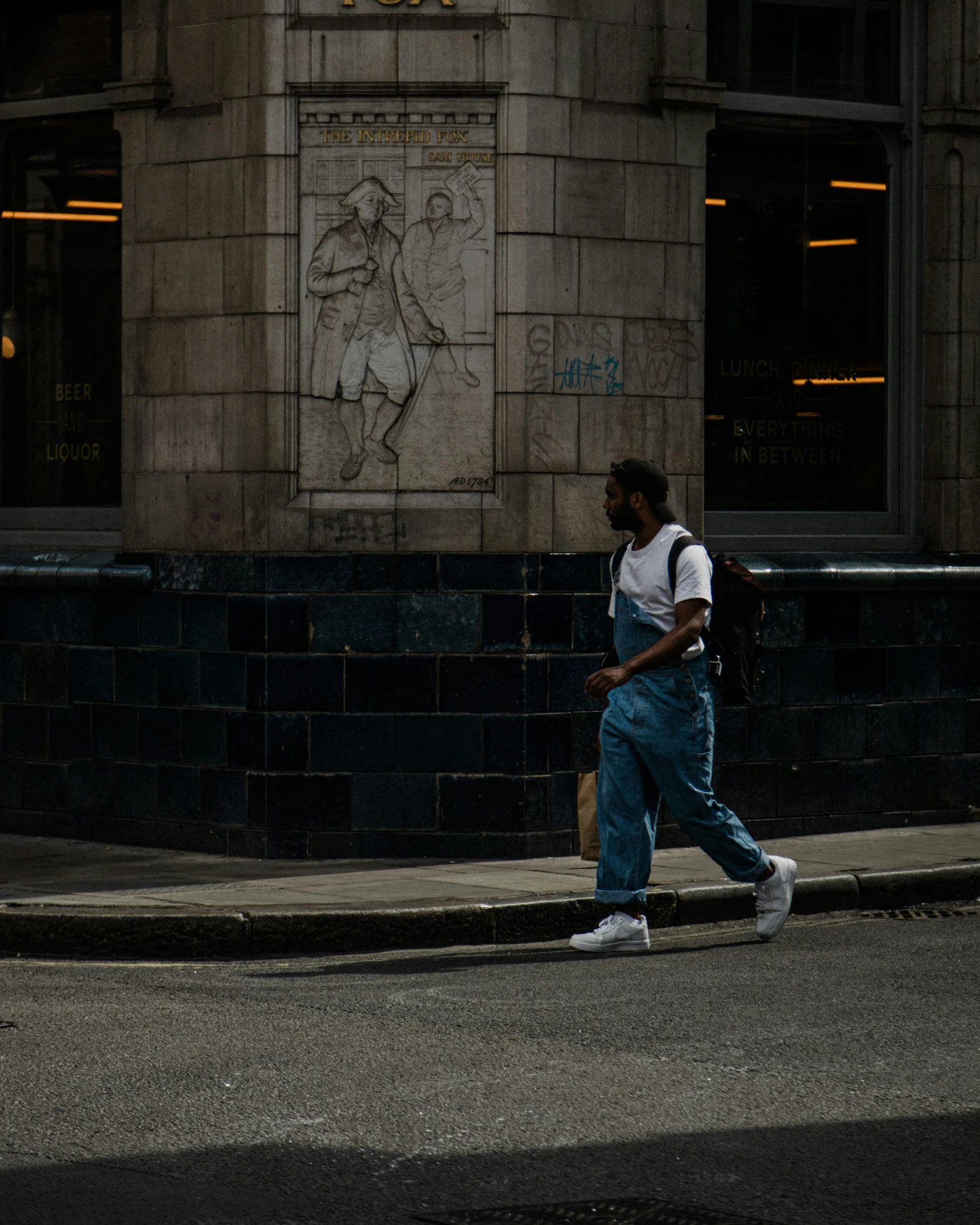 a person crossing the street with a backpack