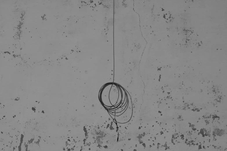 a rope connected to a building with two circles attached