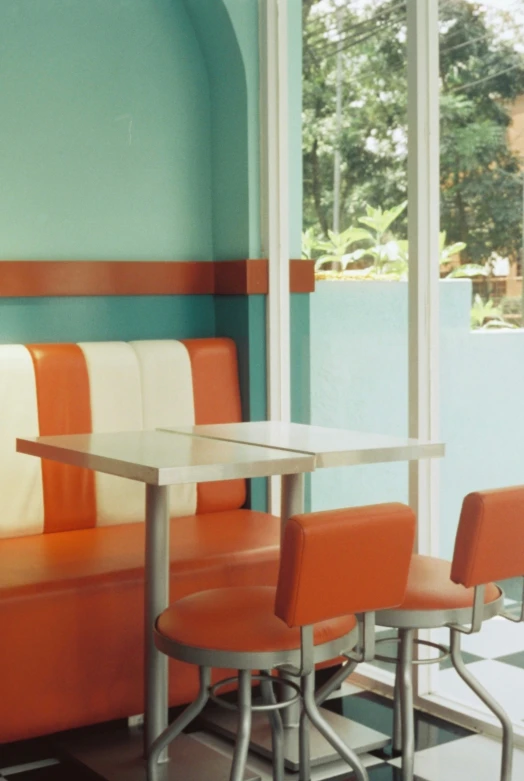 a room with chairs, tables and a sofa with blue walls