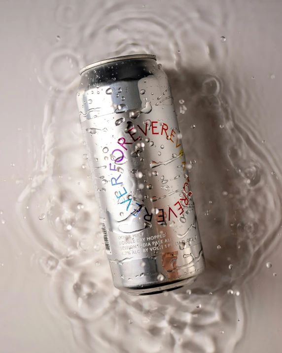 the can has graffiti on it in the water