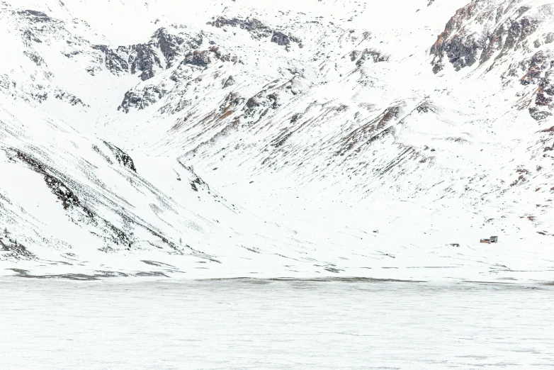 a boat sails across the ocean, among mountains