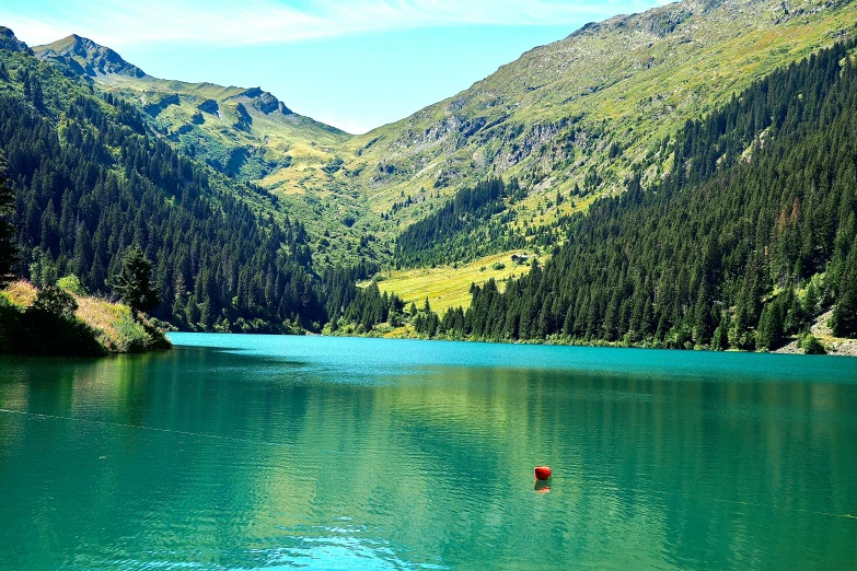 this lake is in the middle of mountains with some trees