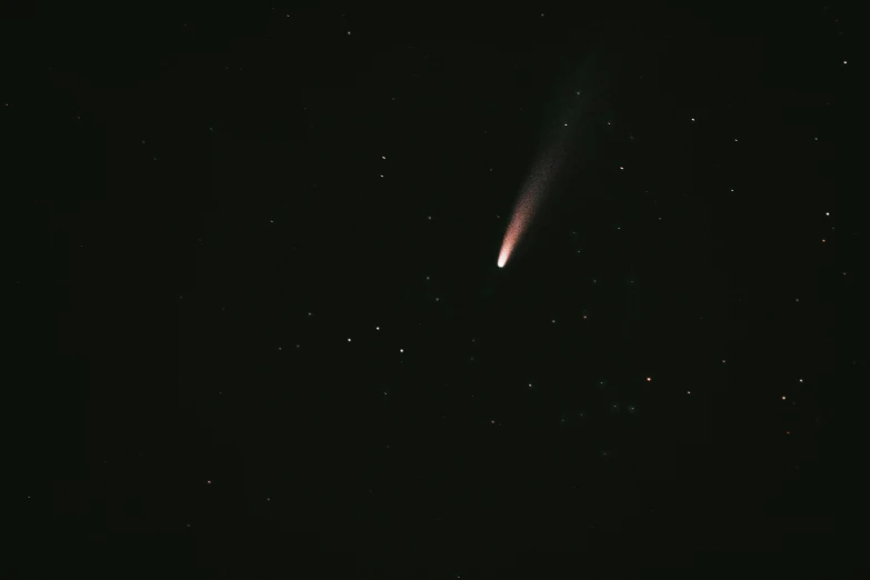 comet in the sky above with bright stars