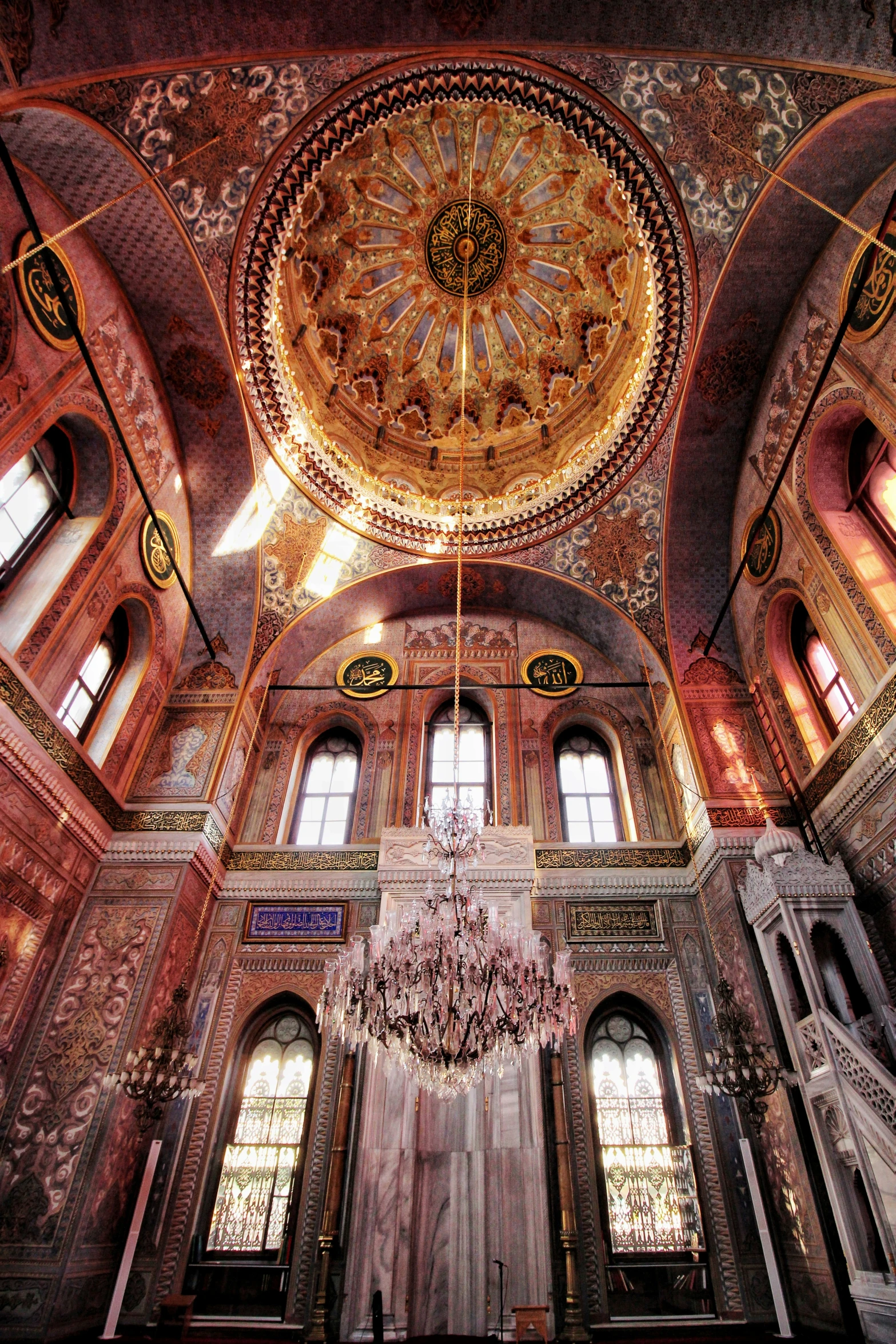 a chandelier suspended from the ceiling in an ornate room