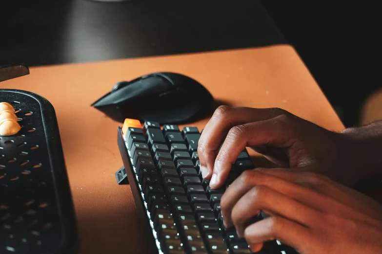 someone is typing on a keyboard at a desk