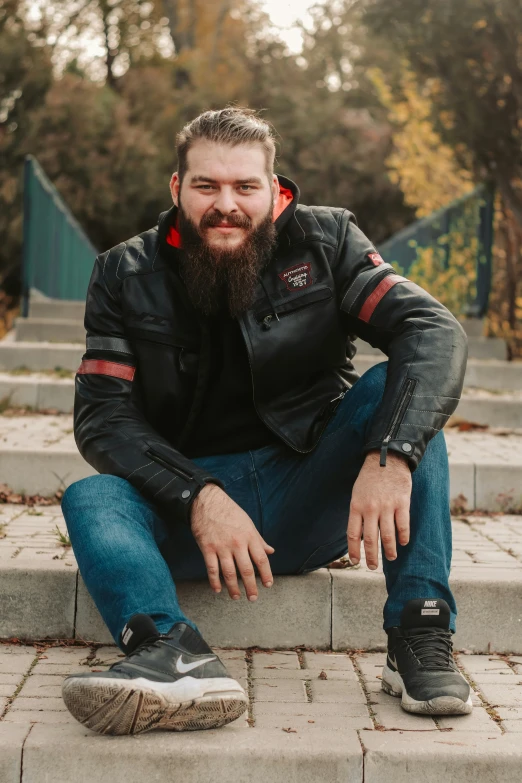 an image of a man with a beard wearing jeans