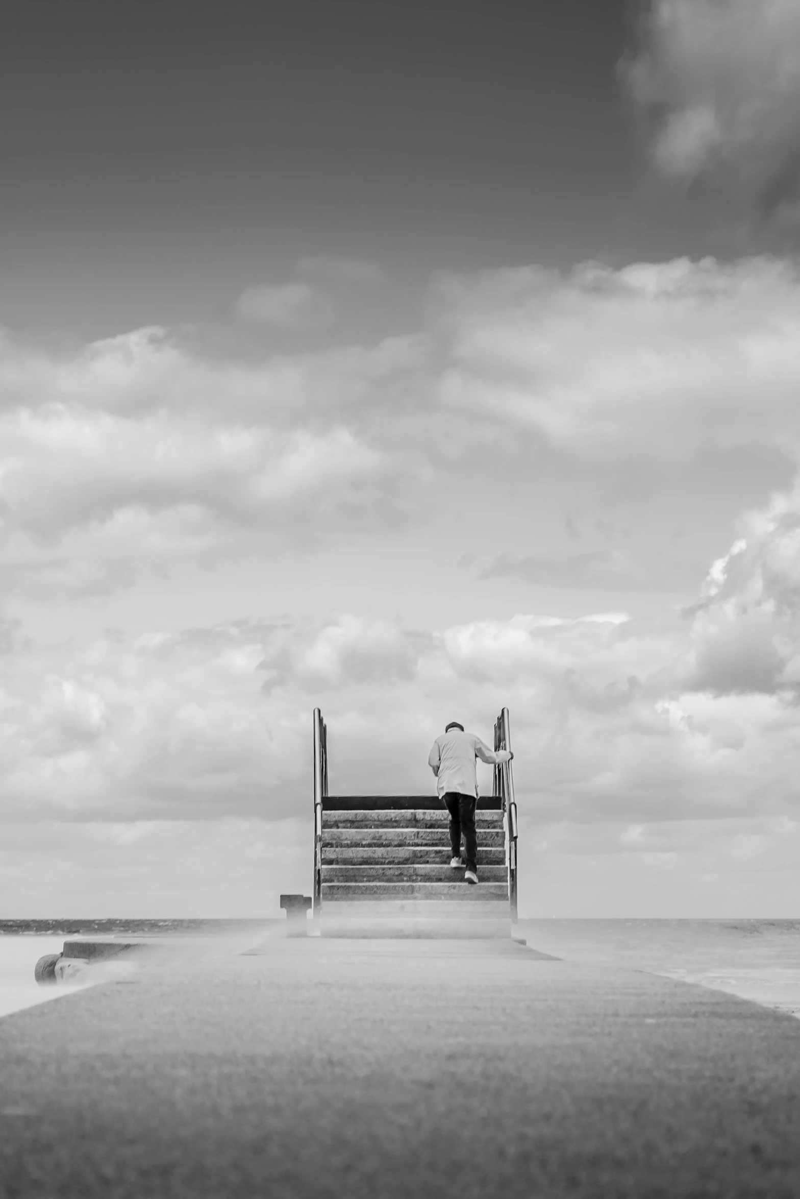 a person standing on a pier by the water