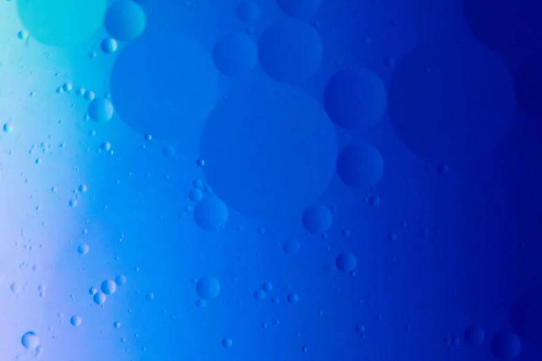 some bubbles in water with some blue sky in the background