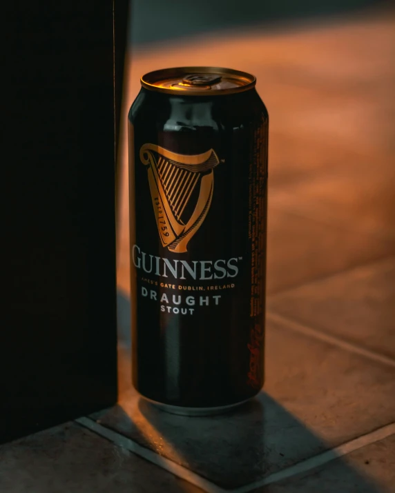 an empty guinness beer can is next to a doorway