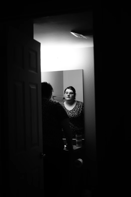 black and white pograph of a women in the mirror