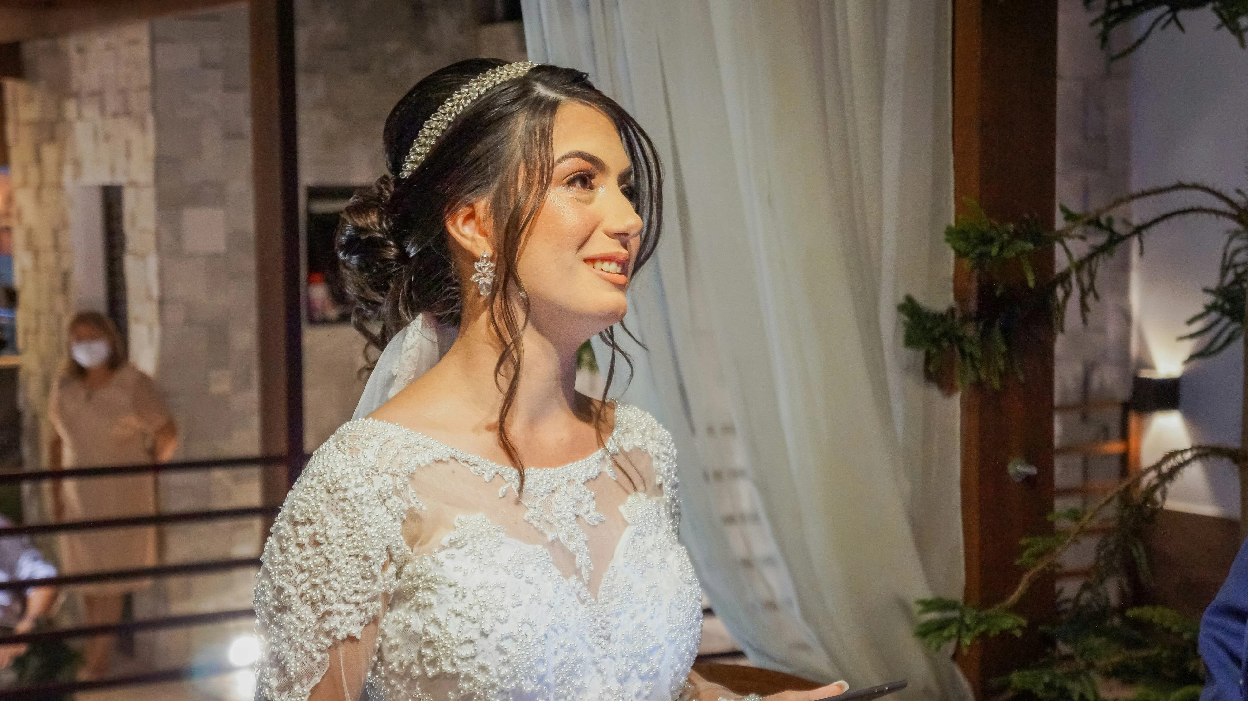 a woman holding a knife next to a mirror