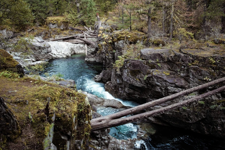 a small stream flowing between two rocky mountains