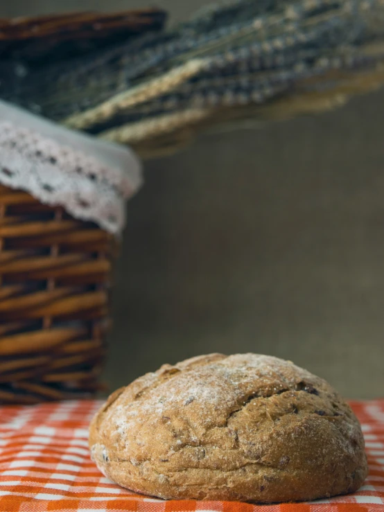 a loaf of bread sitting on top of a cloth covered table