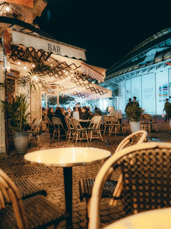 a bunch of tables with chairs on a street