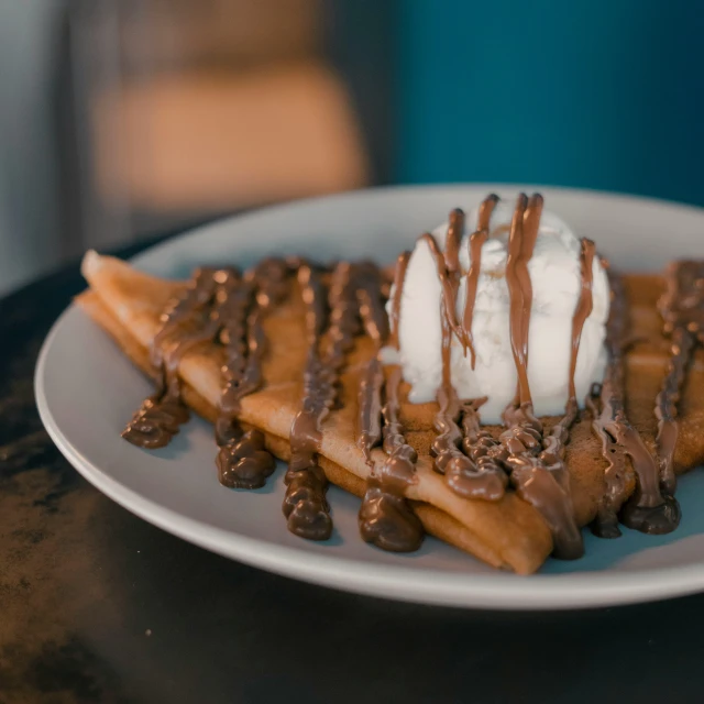 waffles and whip cream served on a white plate