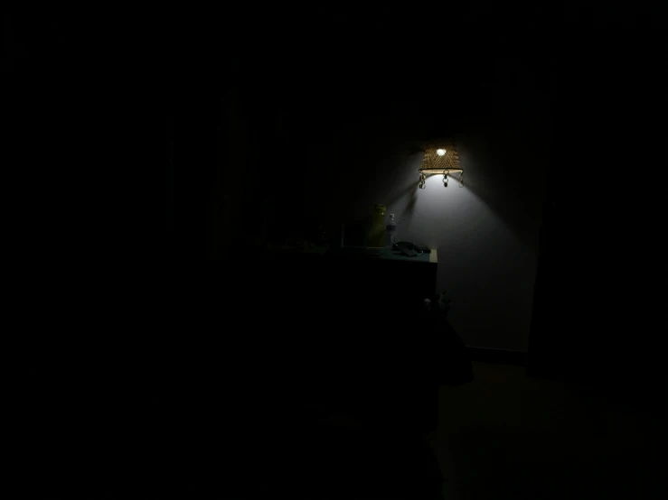 a black wall with a small lamp on it