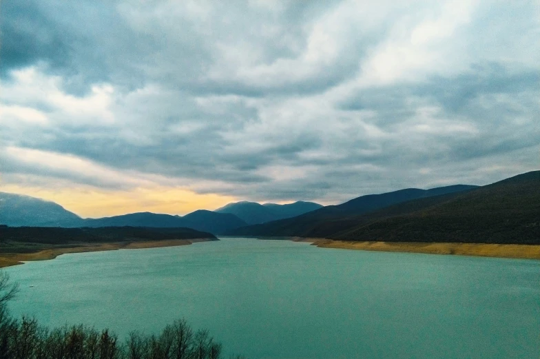 a large body of water with mountains in the background