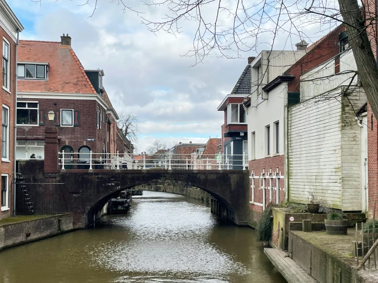 a waterway with houses next to it under a bridge