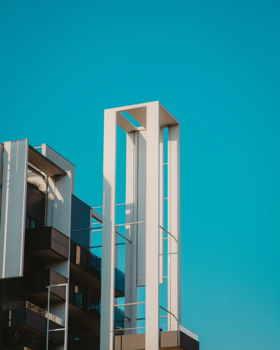 the top of a building with a clock and balcony