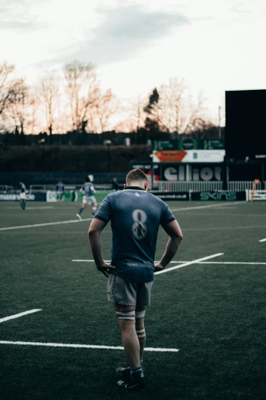 a soccer player standing on a soccer field