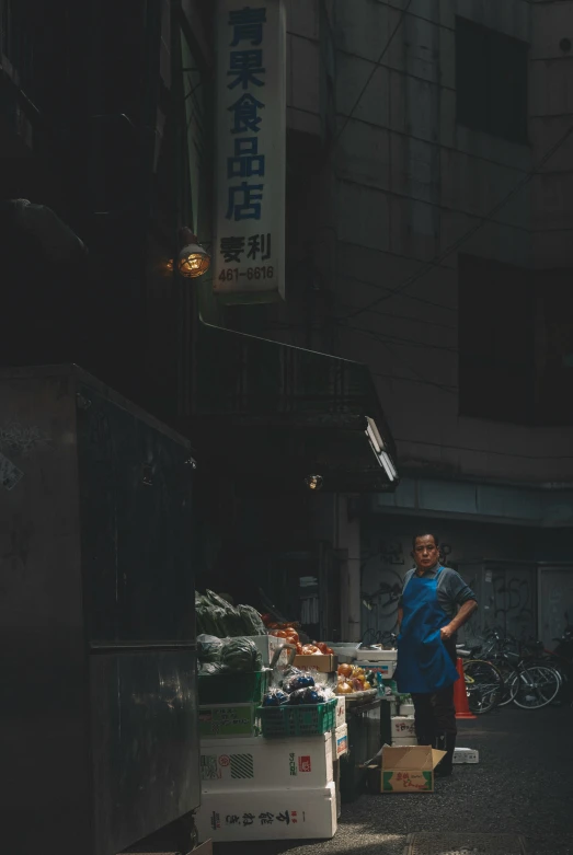 a person stands on the street with containers and boxes