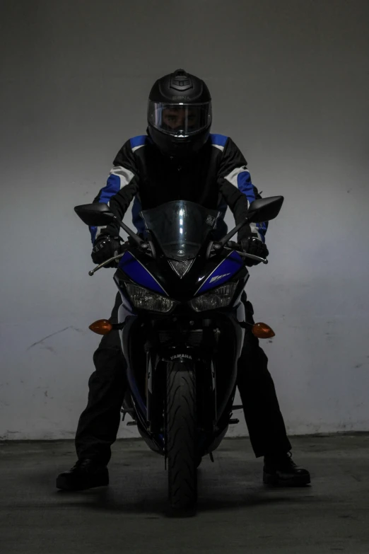 a man in helmet is sitting on a motorcycle
