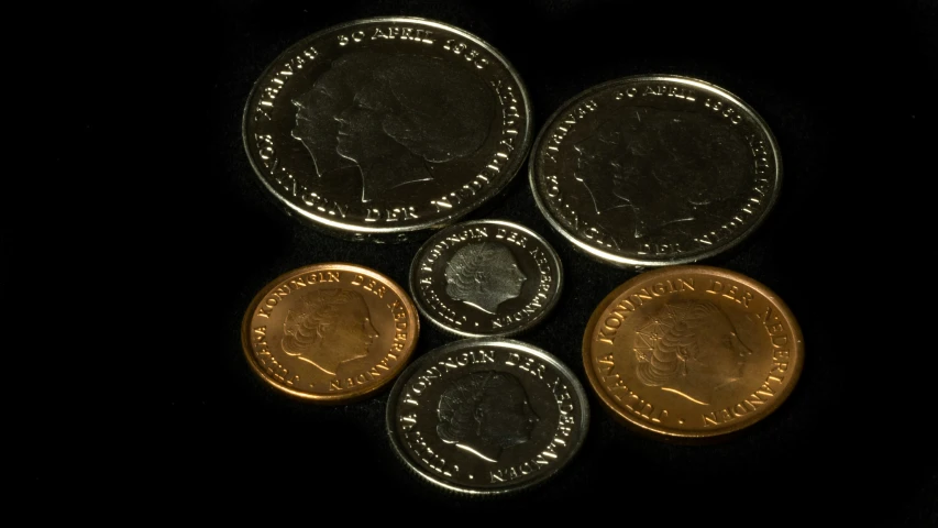 four british pound coins sitting in a pile on a table