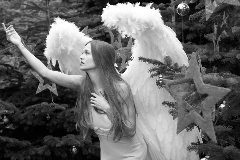 a woman wearing angel wings posing for a pograph