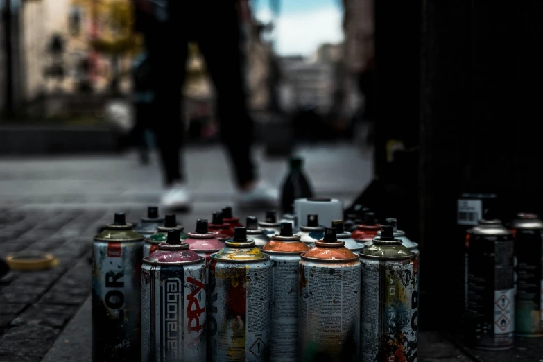 many different beer cans in a row near a man