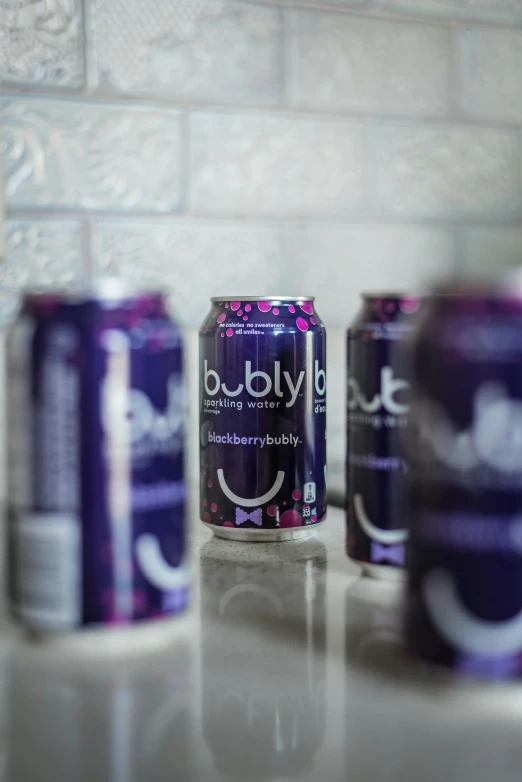 an image of five cans of soda on a table